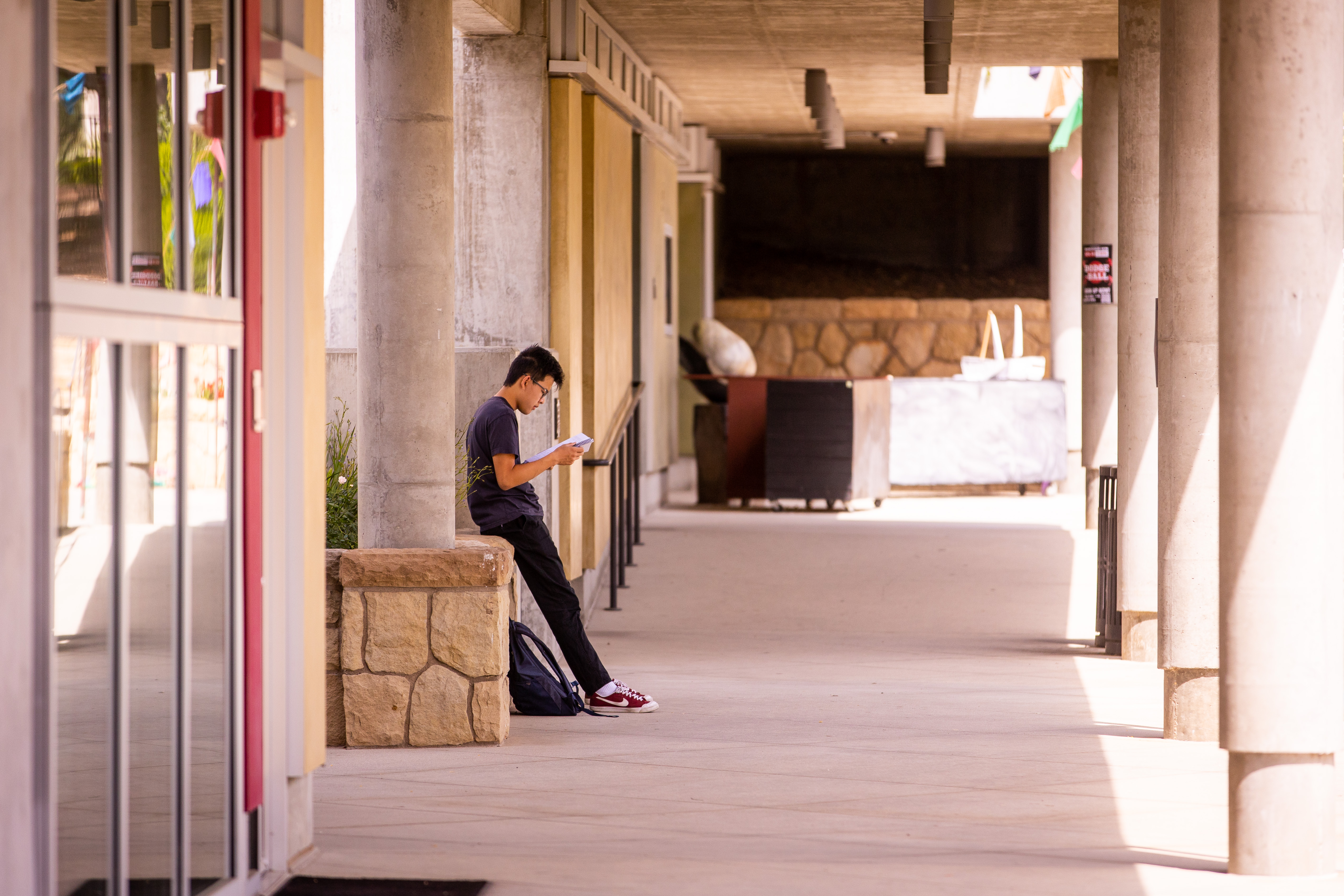 student reading in hallway