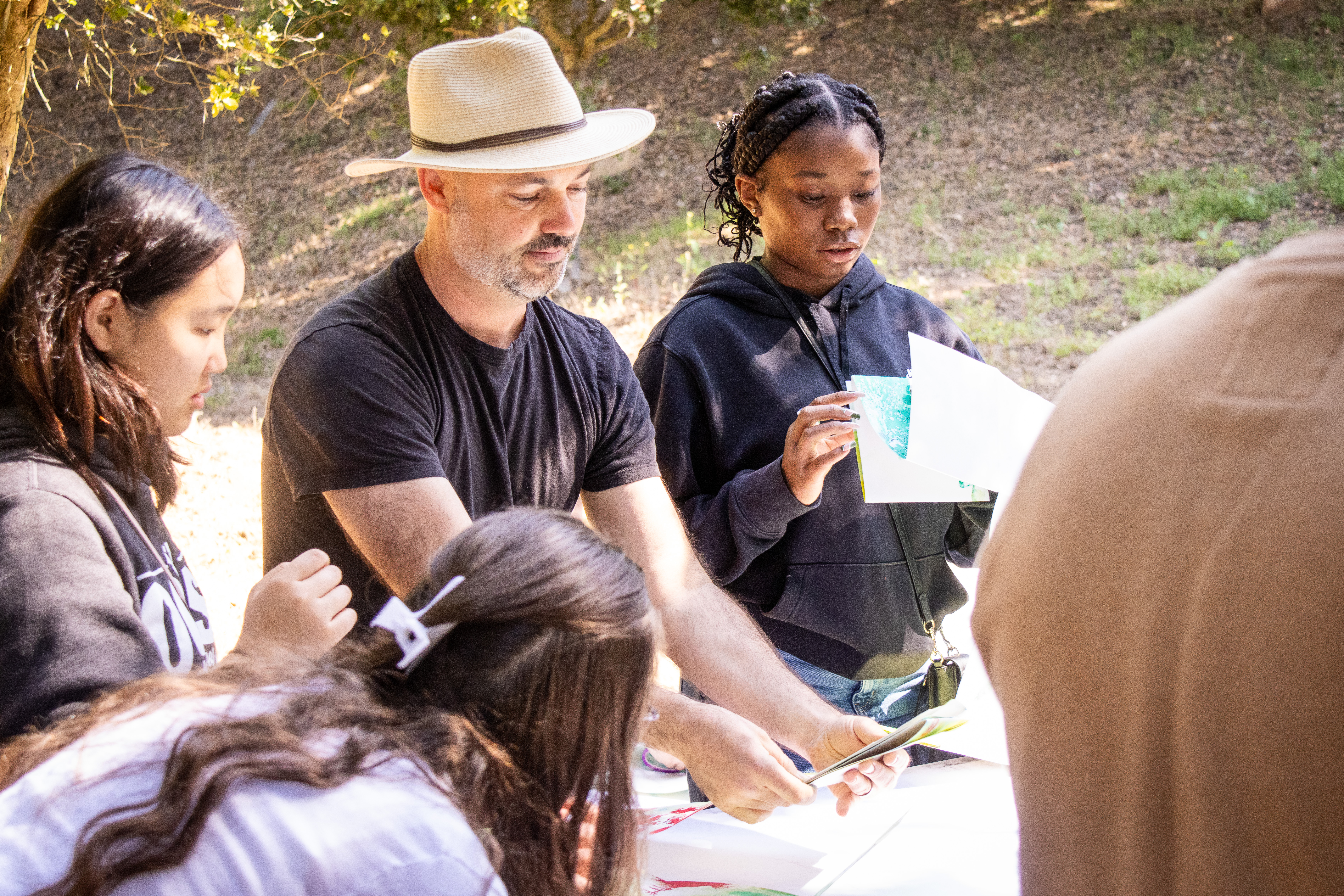 students at trailhead with teacher