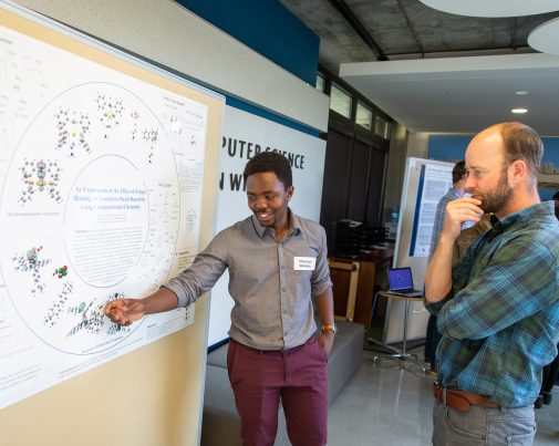 Chisondi Warioba explains his findings to Dr. Tim Van Haitsma. 