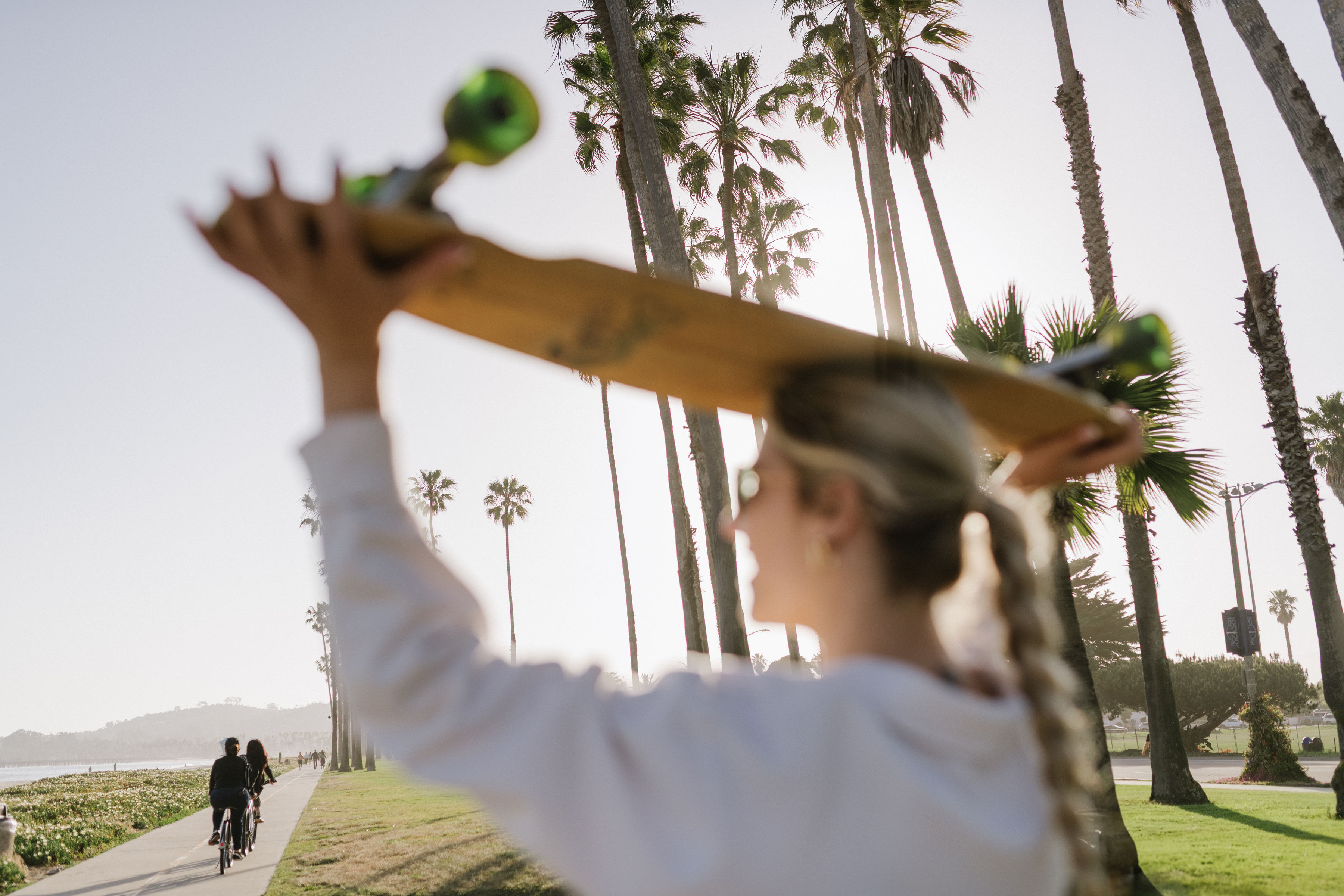 student with longboard on head