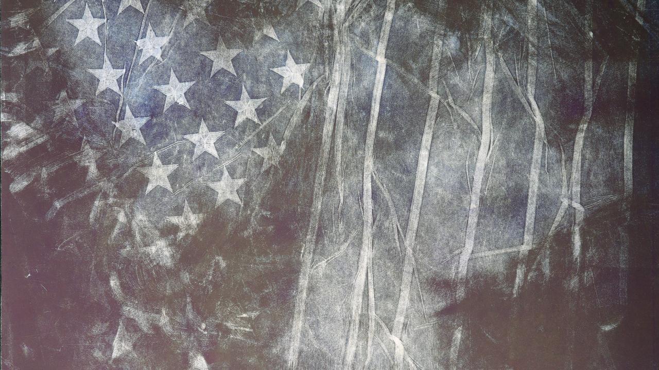 Dark blue monoprint of an American flag.