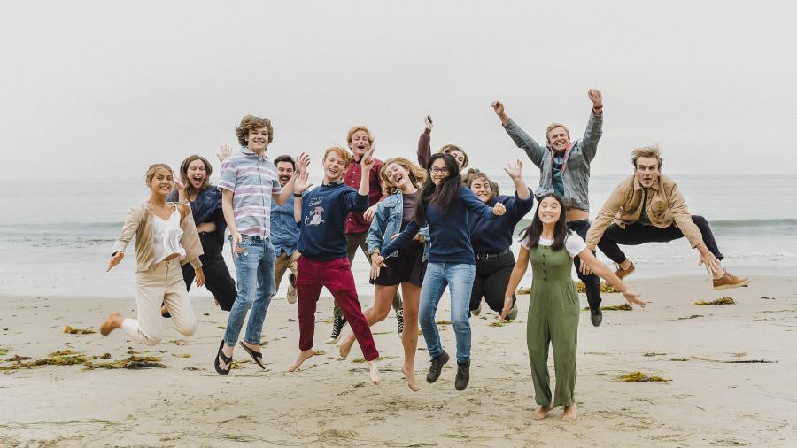 Team jumping on beach